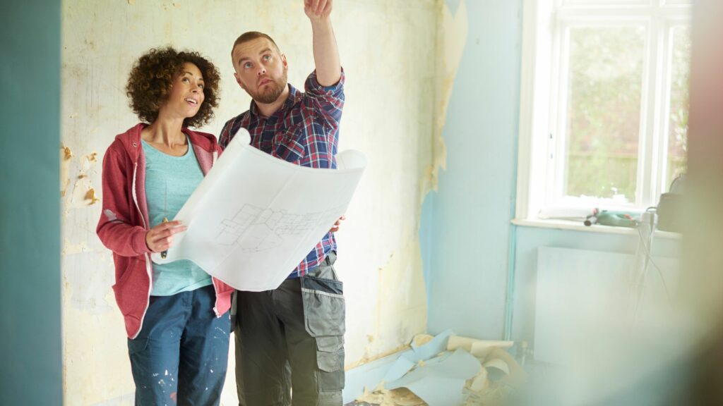 Two homeowners plan while completing remodeling on a budget.